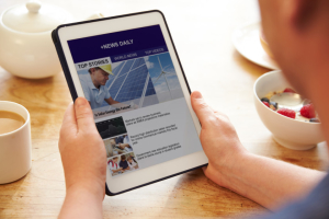 Person At Breakfast Looking At News App On Digital Tablet